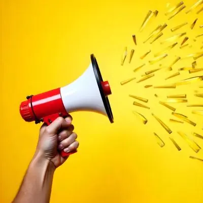 A Hand Holding A Red And White Megaphone With Yellow Rays Coming Out Of It White Background 9 9ad0