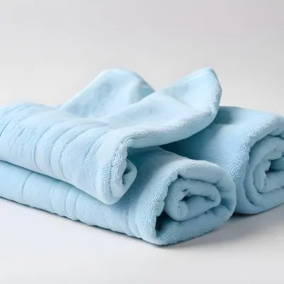 A Light Blue Towel Terrycloth Texture Folded And Crumpled Soft And Absorbent For Drying Or Cleaning On A White Background 5 Be57