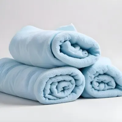 A Light Blue Towel Terrycloth Texture Folded And Crumpled Soft And Absorbent For Drying Or Cleaning On A White Background 9 Bbd0