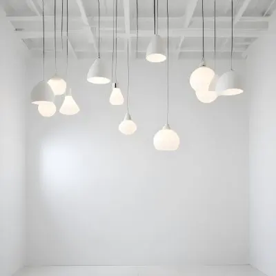 A Minimalist White Room With A High Ceiling And Hanging Pendant Lights 47 D087