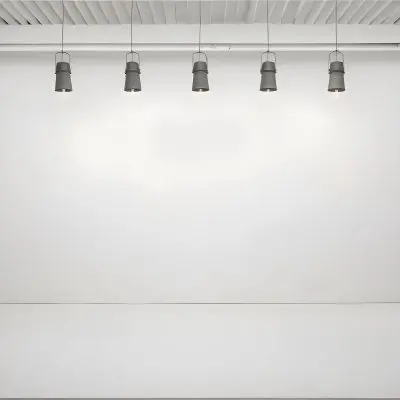 A Minimalist White Room With A High Ceiling And Hanging Pendant Lights 56 C74f