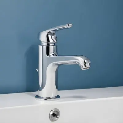 A Shiny Chrome Faucet With A Lever Handle Positioned On A White Countertop Set Against A Plain Blue Wall Showcasing A Modern Bathroom Fixture 13 B6a2