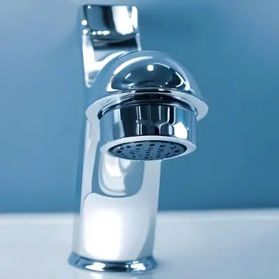 A Shiny Chrome Faucet With A Lever Handle Positioned On A White Countertop Set Against A Plain Blue Wall Showcasing A Modern Bathroom Fixture 6 6fc9