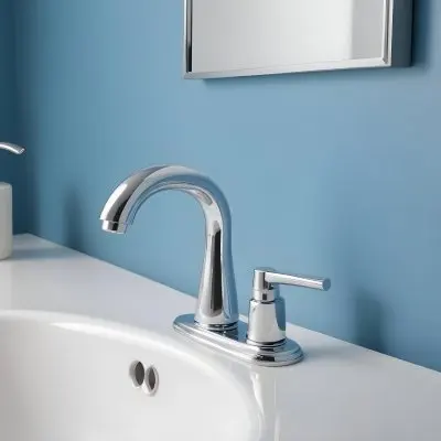 A Shiny Chrome Faucet With A Lever Handle Positioned On A White Countertop Set Against A Plain Blue Wall Showcasing A Modern Bathroom Fixture 9 6add