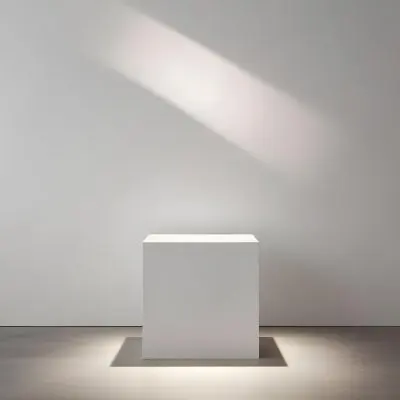 A White Cube Shaped Object On A Plain Background With A Bright Light Source Above It 9 C49a