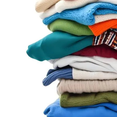 Pile Of White Folded Clothes Including Sweaters Pants And Sweaters Stacked Haphazardly On Top Of Each Other Creating A Organized And Organized Mess Colorful Background 23 A591