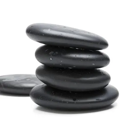 Stack Of Wet White Stones In A Black