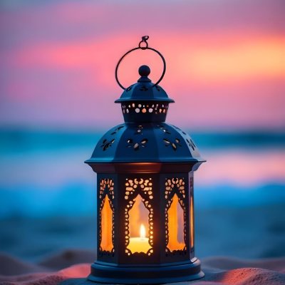 A Black Metal Lantern With Intricate Cutouts Glowing With Warm Light Sits On A Sandy Beach With A Vibrant Pink And Blue Sunset Sky 8 Ecbf