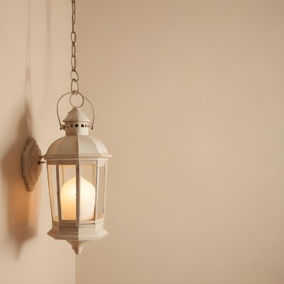 A Hanging Lantern With A Warm Glowing Light Against A Plain Beige Wall 10 9d88