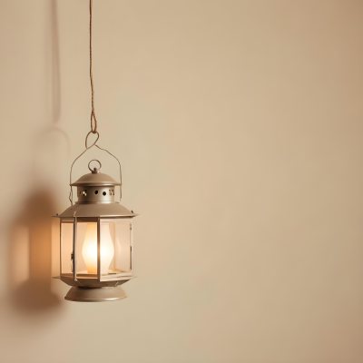 A Hanging Lantern With A Warm Glowing Light Against A Plain Beige Wall 11 D25b
