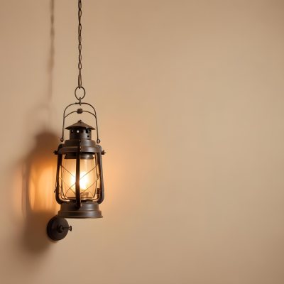 A Hanging Lantern With A Warm Glowing Light Against A Plain Beige Wall 51 1c72