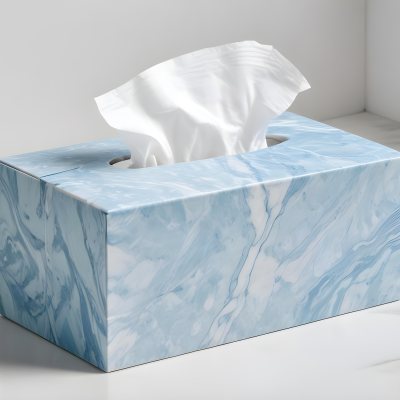 A Light Blue Tissue Box With A Marble Pattern Filled With White Tissues Sitting On A White Surface With A White Background 6 3b21