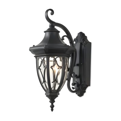 An Ornate Black Metal Outdoor Wall Sconce With A Glass Pane Design Mounted On A Brick Wall 9 72a3