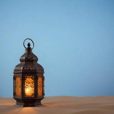 An Ornate Metal Lantern With Intricate Floral Cutouts Casting A Warm Glow On A Sandy Surface Against A Soft Gradient Blue Background 6 3b6c