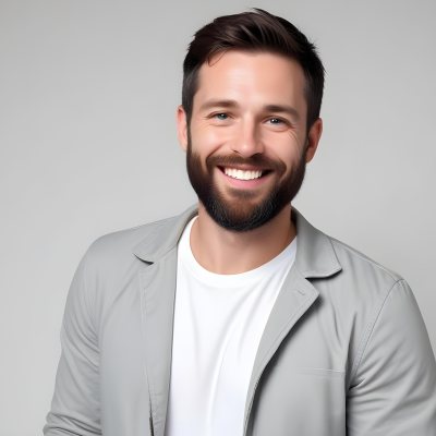 A White Man 35 Years Old With Short Dark Hair And A Beard Wearing A White T Shirt And A Gray Jacket Smiling In A White Background 14 Dc2c