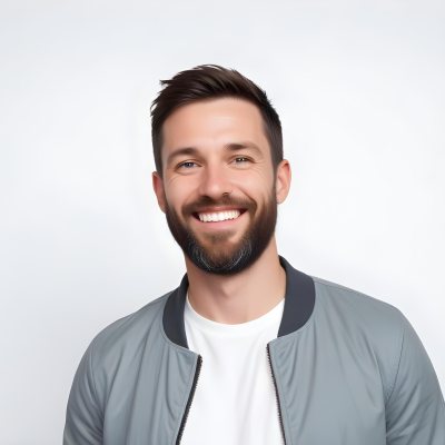 A White Man 35 Years Old With Short Dark Hair And A Beard Wearing A White T Shirt And A Gray Jacket Smiling In A White Background 22 306f