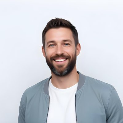 A White Man 35 Years Old With Short Dark Hair And A Beard Wearing A White T Shirt And A Gray Jacket Smiling In A White Background 33 9400