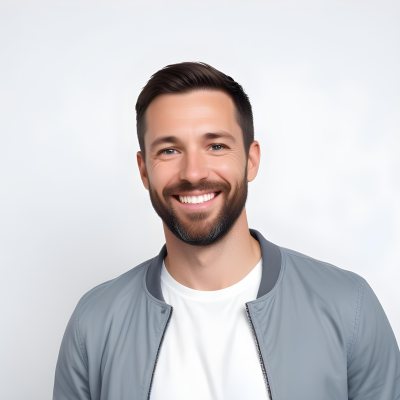 A White Man 35 Years Old With Short Dark Hair And A Beard Wearing A White T Shirt And A Gray Jacket Smiling In A White Background 7 870d