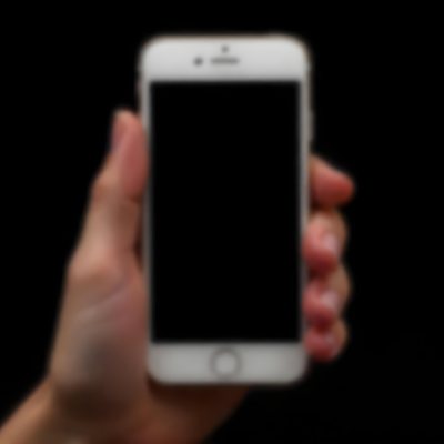 A Fair Skinned Hand Holding A White Smartphone With A Blank Black Screen Isolated On A Black Background 6 97b1