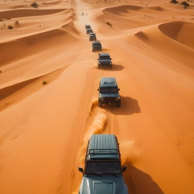 A Convoy Of Off Road Vehicles Driving Through A Vast Sandy Desert Landscape With Rolling Dunes 3 0fbd