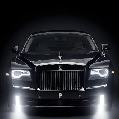A Sleek Dark Colored Luxury Sedan With A Prominent Grille Featuring The Rolls Royce Logo Illuminated Headlights And A Minimalist Elegant Design 2 Ce2e