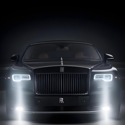 A Sleek Dark Colored Luxury Sedan With A Prominent Grille Featuring The Rolls Royce Logo Illuminated Headlights And A Minimalist Elegant Design 20 5cd0
