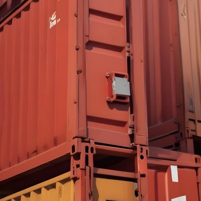 Red Cargo Containers Stacked On Top Of Each Other With A Metal Latch Visible On The Side Of One Of The Containers In A Sunny Environment Against A Background Of A Shipping Yard 23 8211